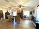Inviting living room with a stone fireplace, comfortable seating, ceiling fans and bright natural light at 6701 Se 99Th Pl, Belleview, FL 34420