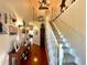 Bright foyer staircase with carpeted steps and decorative accents leading to the second floor with hardwood floors and a view to the foyer at 6701 Se 99Th Pl, Belleview, FL 34420
