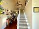An impressive foyer with an elegant staircase and lovely decorations at 6701 Se 99Th Pl, Belleview, FL 34420