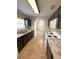 Kitchen with dark cabinets, white appliances, and view of living room at 73 Fir Dr, Ocala, FL 34472