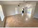 Bright living room with tile floors, access to patio, and ceiling fans at 73 Fir Dr, Ocala, FL 34472