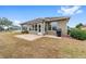 Home's backyard with patio, lawn, and grill at 7358 Sw 101St Ave, Ocala, FL 34481