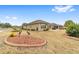 Landscaped backyard with stone accents and home view at 7358 Sw 101St Ave, Ocala, FL 34481