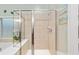 Bathroom with shower stall, tiled walls, and a built-in shelf at 7358 Sw 101St Ave, Ocala, FL 34481