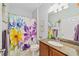 Bathroom with floral shower curtain and granite countertop at 7358 Sw 101St Ave, Ocala, FL 34481