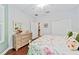 Bedroom with floral bedding, wood floors, and a dresser at 7358 Sw 101St Ave, Ocala, FL 34481