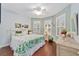 Bedroom with floral bedding, wood floors, and large windows at 7358 Sw 101St Ave, Ocala, FL 34481