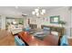 Dining room with dark wood table, blue chairs, and view into living room at 7358 Sw 101St Ave, Ocala, FL 34481
