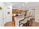 Kitchen features wood cabinets, granite island, and breakfast bar at 7358 Sw 101St Ave, Ocala, FL 34481
