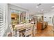 Bright kitchen breakfast nook with wood table and chairs, hardwood floors and access to screened patio at 7358 Sw 101St Ave, Ocala, FL 34481