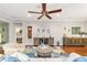 Living room features hardwood floors, ceiling fan and comfortable furniture at 7358 Sw 101St Ave, Ocala, FL 34481