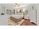 Main bedroom with king-size bed, ceiling fan and hardwood floors at 7358 Sw 101St Ave, Ocala, FL 34481