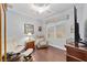 Office with recliner, wood floors, and built-in shelving at 7358 Sw 101St Ave, Ocala, FL 34481