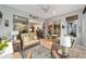 Sunroom with wicker furniture and view into the kitchen at 7358 Sw 101St Ave, Ocala, FL 34481