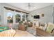Bright sunroom features wicker furniture and a view of the backyard at 7358 Sw 101St Ave, Ocala, FL 34481