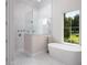 Spa-like bathroom with soaking tub, walk-in shower, and marble tile at 7647 Nw 33Rd Pl, Ocala, FL 34482