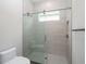Bathroom with a glass enclosed shower and gray tile at 7647 Nw 33Rd Pl, Ocala, FL 34482