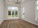 Spacious bedroom with hardwood floors and large windows at 7647 Nw 33Rd Pl, Ocala, FL 34482