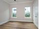 Spacious bedroom with hardwood floors and dual windows at 7647 Nw 33Rd Pl, Ocala, FL 34482