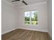 Bright bedroom with hardwood floors and large window at 7647 Nw 33Rd Pl, Ocala, FL 34482