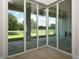 Sliding glass doors offer picturesque golf course views at 7647 Nw 33Rd Pl, Ocala, FL 34482