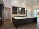 Gourmet kitchen boasts dark cabinetry, quartz counters, and a large island at 7647 Nw 33Rd Pl, Ocala, FL 34482
