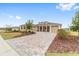 Two-story house with a double garage, covered porch, and brick paver driveway at 8160 Sw 92Nd Cir, Ocala, FL 34481