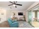 Living room boasting hardwood floors, a ceiling fan, and access to a sunroom at 8310 Sw 79Th Cir, Ocala, FL 34481