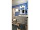 Updated bathroom with white vanity, blue walls, and walk-in shower at 8512 Sw 107Th Pl, Ocala, FL 34481