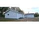 Side view of a single story home with gray siding, and mature trees at 8512 Sw 107Th Pl, Ocala, FL 34481