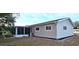 Rear view of a single story home with gray siding and screened porch at 8512 Sw 107Th Pl, Ocala, FL 34481