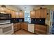Galley kitchen with stainless steel appliances and black tile backsplash at 8512 Sw 107Th Pl, Ocala, FL 34481