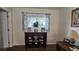 Dark brown side table with Gathering photos and decor at 8512 Sw 107Th Pl, Ocala, FL 34481