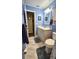 Bathroom with blue walls, a sink with mirror, toilet, and tile floors at 8512 Sw 107Th Pl, Ocala, FL 34481