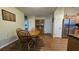 Dining area features wood table and chairs, wood-look floors, and natural light at 8512 Sw 107Th Pl, Ocala, FL 34481