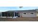 Rear exterior view of home with screened enclosure, and manicured lawn at 8512 Sw 107Th Pl, Ocala, FL 34481