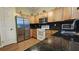 Cozy kitchen with stainless steel appliances, light wood cabinets, and dark countertops at 8512 Sw 107Th Pl, Ocala, FL 34481