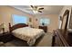 Bright main bedroom featuring a decorative bedspread, ceiling fan, and lots of natural light at 8512 Sw 107Th Pl, Ocala, FL 34481
