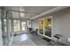 Enclosed sunroom with sliding glass doors, neutral color, and outdoor furniture at 8512 Sw 107Th Pl, Ocala, FL 34481