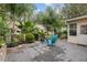 Landscaped backyard with patio, fire pit, and lush greenery at 8723 Sw 93Rd Ln # C, Ocala, FL 34481