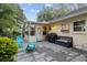 Relaxing backyard patio with seating area, grill, and lush landscaping at 8723 Sw 93Rd Ln # C, Ocala, FL 34481