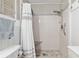 Modern bathroom highlighting the tile shower with a built-in seat and grab bar at 8723 Sw 93Rd Ln # C, Ocala, FL 34481