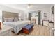 Spacious bedroom with wood-like flooring and a large bed at 8723 Sw 93Rd Ln # C, Ocala, FL 34481