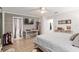 King-size bed in a bedroom with wood-look floors and TV at 8723 Sw 93Rd Ln # C, Ocala, FL 34481
