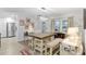 Well-lit dining area with natural light, features a table with bench seating, and modern appliances at 8723 Sw 93Rd Ln # C, Ocala, FL 34481