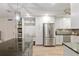 Modern kitchen featuring stainless steel appliances, a functional built-in bench with storage and white cabinets at 8723 Sw 93Rd Ln # C, Ocala, FL 34481