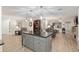 Open floor plan features a kitchen island that overlooks a living space with comfortable seating at 8723 Sw 93Rd Ln # C, Ocala, FL 34481