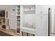 White kitchen cabinets and built-in bench with storage at 8723 Sw 93Rd Ln # C, Ocala, FL 34481