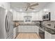 Well-lit kitchen boasts stainless steel appliances, granite counters, white cabinets, and modern backsplash at 8723 Sw 93Rd Ln # C, Ocala, FL 34481