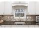Modern kitchen sink with granite countertop and tile backsplash at 8723 Sw 93Rd Ln # C, Ocala, FL 34481